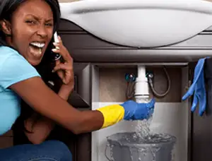 Emergency plumbing repair for a leaking sink drain under a bathroom vanity in San Francisco, CA