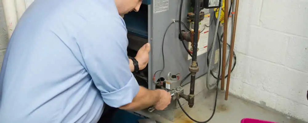 Furnace repair technician inspecting and servicing a home heating system in San Francisco, CA