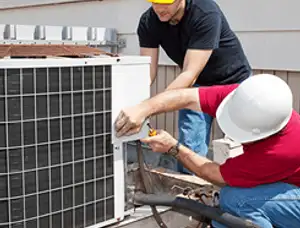 HVAC technicians repairing an outdoor AC unit on a rooftop in San Francisco, CA