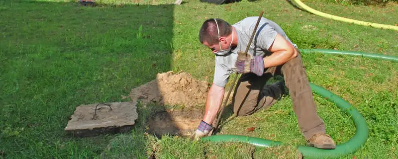 Septic pumping technician servicing a residential septic tank in San Francisco, CA